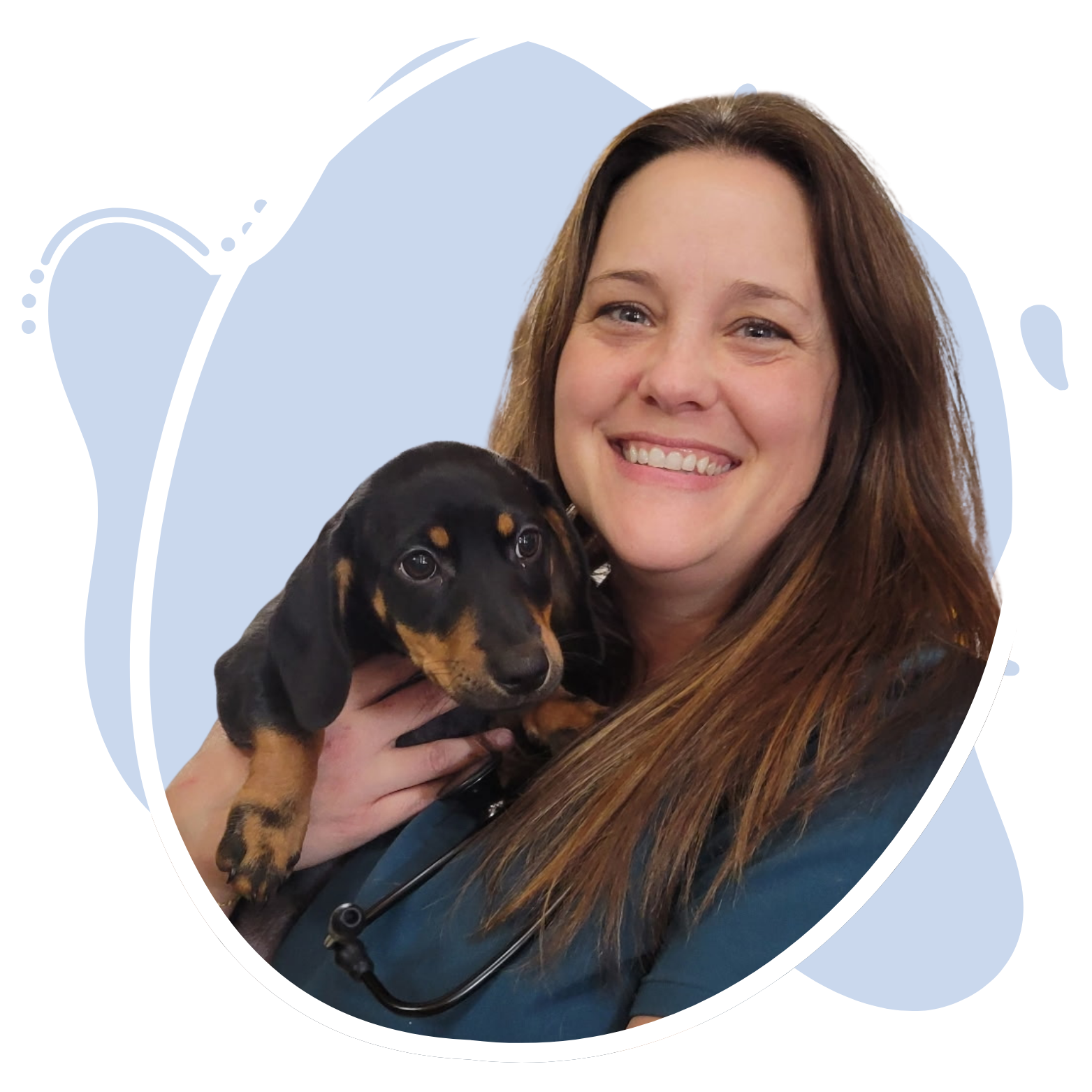 Dr. Carey Bachman holding a small dog.